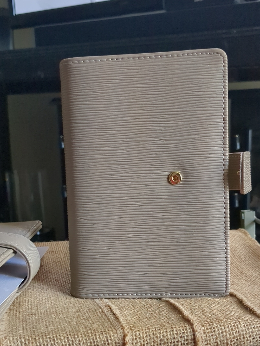 Taupe Textured Saffiano Binder With Gold Hardware.